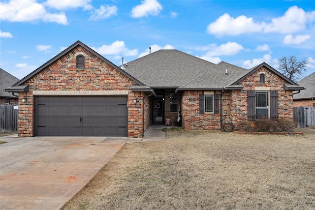 view of front of house featuring a front lawn and a garage