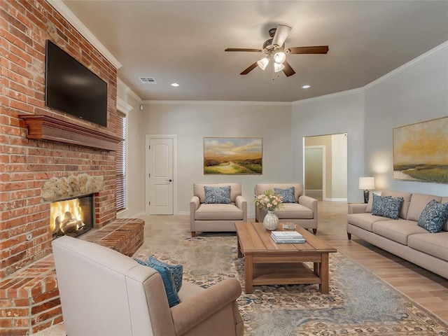 living area featuring visible vents, ornamental molding, light wood-style floors, a brick fireplace, and baseboards