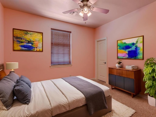 bedroom with light carpet, ceiling fan, and visible vents