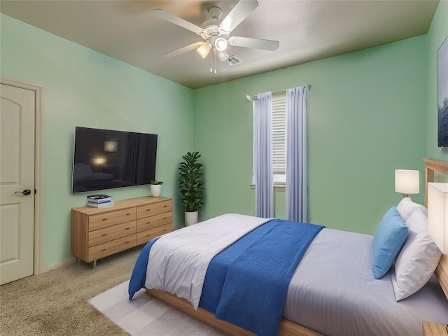 bedroom with visible vents, a ceiling fan, and light colored carpet