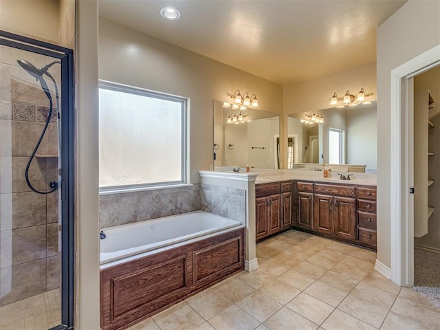 bathroom featuring tile patterned floors, a shower stall, a bath, and vanity