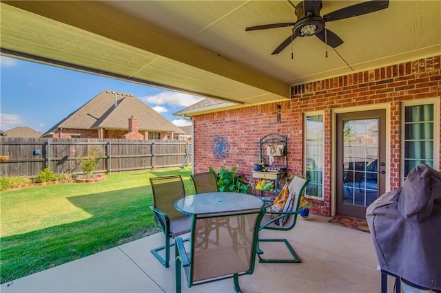 view of patio featuring ceiling fan, outdoor dining space, and a fenced backyard