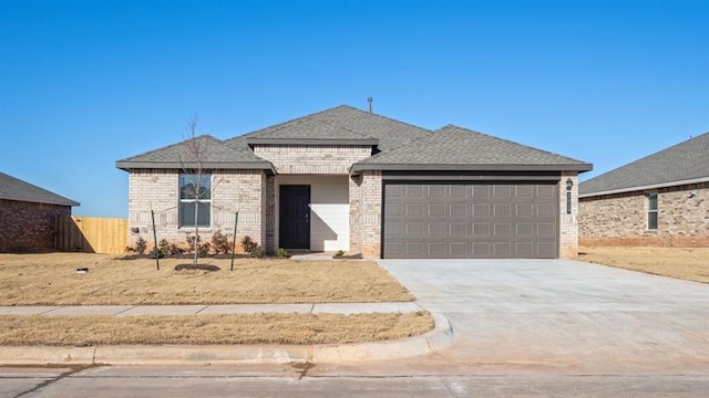 view of front of property with concrete driveway, brick siding, an attached garage, and fence