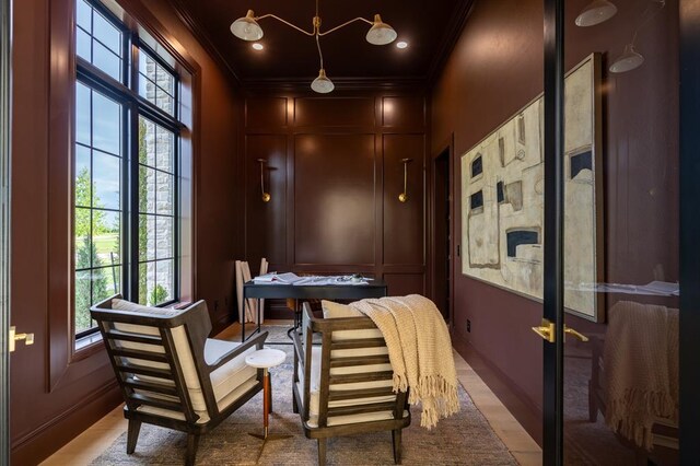 20945 Alba Ct, Edmond, OK 73012 - home office with ornamental molding, healthy amount of natural light, a decorative wall, light wood-style flooring, and baseboards