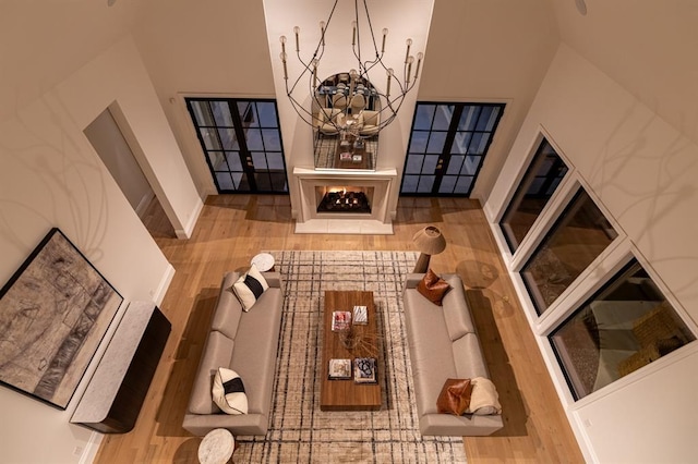20945 Alba Ct, Edmond, OK 73012 - living room with wood finished floors, a chandelier, and baseboards