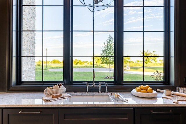 20945 Alba Ct, Edmond, OK 73012 - kitchen view of light stone countertops and a sink