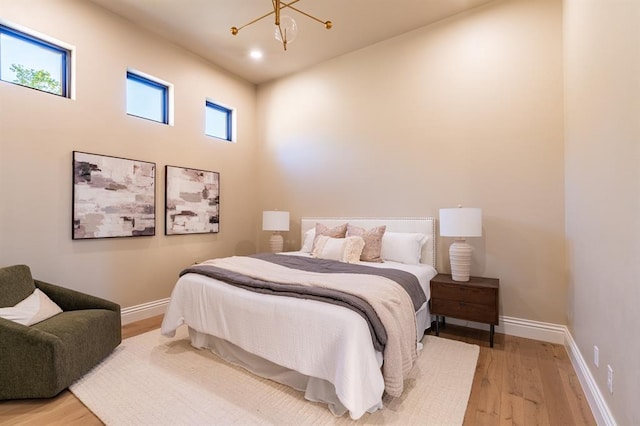 20945 Alba Ct, Edmond, OK 73012 - bedroom featuring light wood-style flooring, a chandelier, baseboards, and recessed lighting