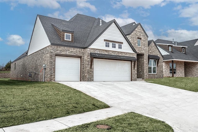 view of front of home with a shingled roof, a front yard, brick siding, and driveway