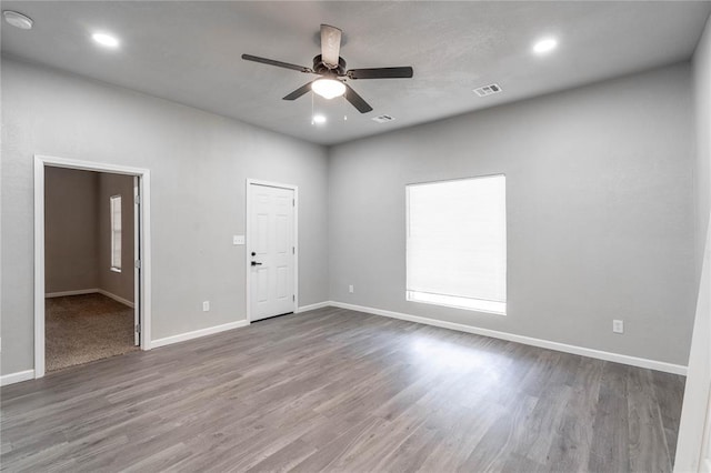 spare room with ceiling fan and wood-type flooring