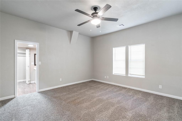 unfurnished room with ceiling fan and carpet flooring