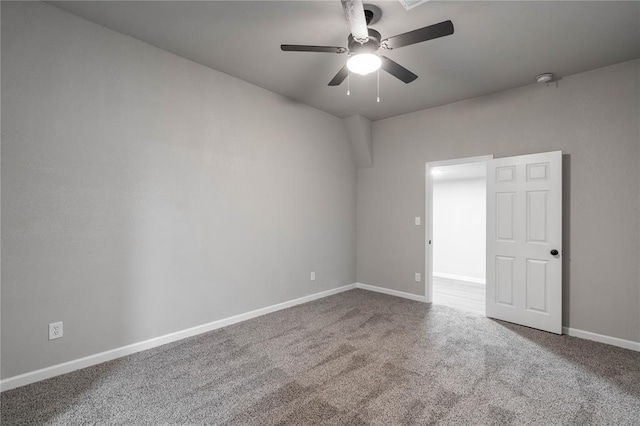 spare room featuring carpet and ceiling fan