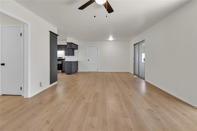 unfurnished living room featuring light wood-style floors, baseboards, and a ceiling fan