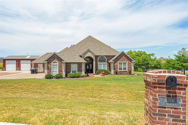 view of front of property with a garage, brick siding, roof with shingles, and a front yard