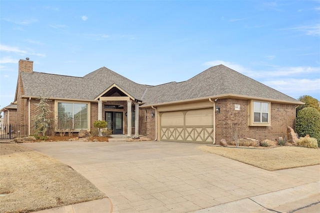 single story home featuring brick siding, a chimney, and an attached garage