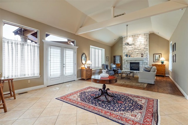 living area with baseboards, a fireplace, visible vents, and light tile patterned flooring