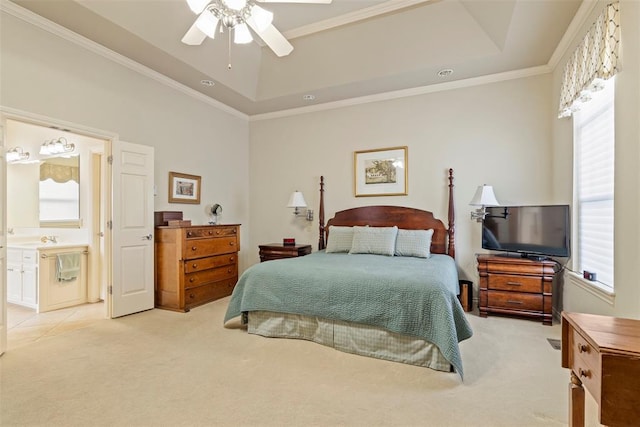 bedroom with a tray ceiling, light carpet, and multiple windows