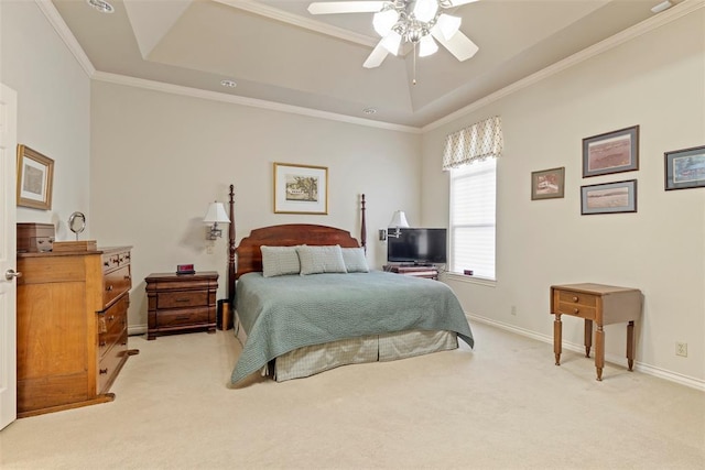 bedroom with ornamental molding, a tray ceiling, and light carpet