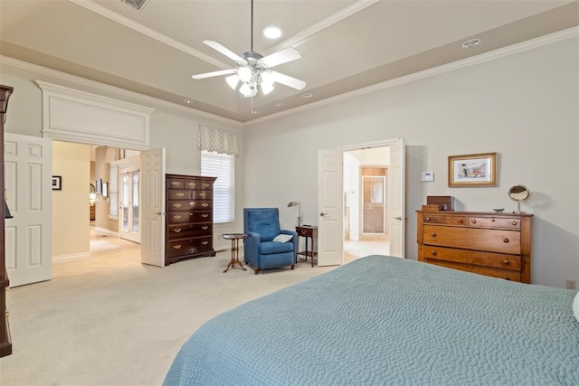 bedroom featuring a tray ceiling, light colored carpet, crown molding, and ceiling fan