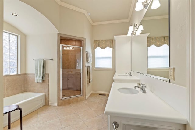 bathroom with a shower stall, a sink, tile patterned flooring, and crown molding