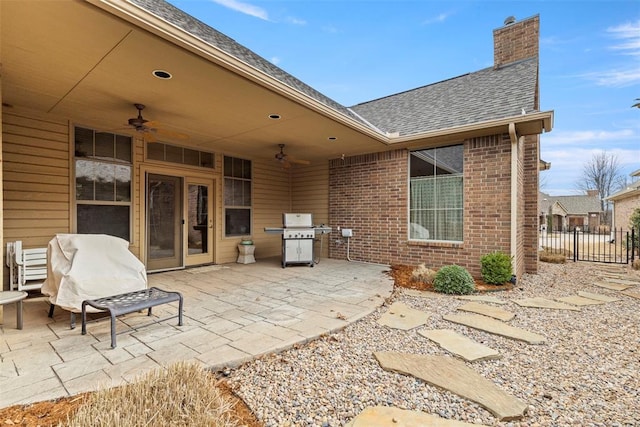 view of patio featuring a grill, fence, and a ceiling fan