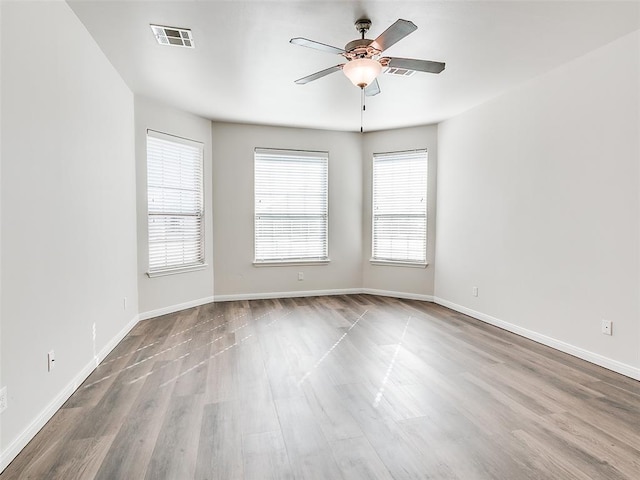 unfurnished room with visible vents, baseboards, and ceiling fan