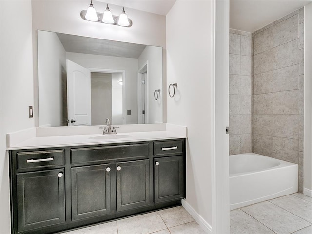 bathroom featuring tile patterned floors, bathtub / shower combination, vanity, and baseboards