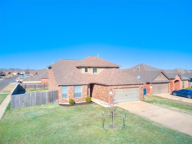 view of front of property with a front yard, fence, an attached garage, concrete driveway, and brick siding