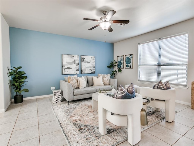 living room featuring light tile patterned floors, a ceiling fan, and baseboards