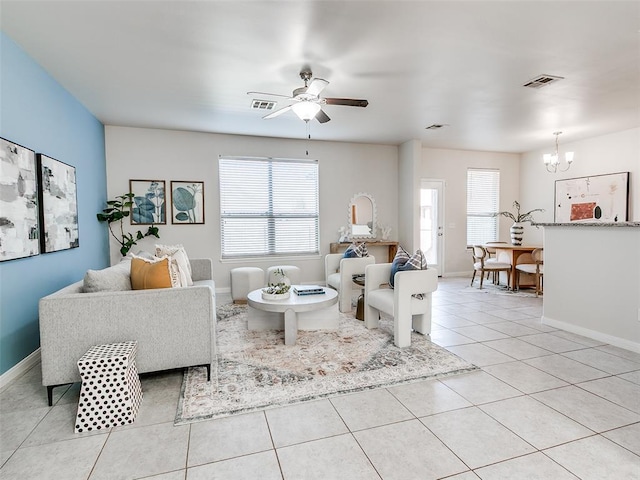 living room with light tile patterned floors, visible vents, and a healthy amount of sunlight