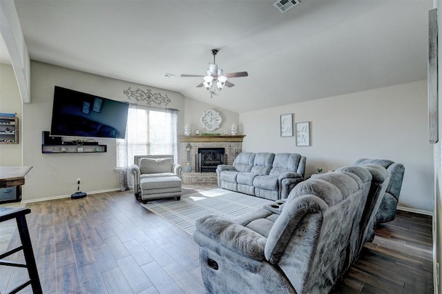 living room with wood-type flooring, lofted ceiling, a fireplace, and ceiling fan