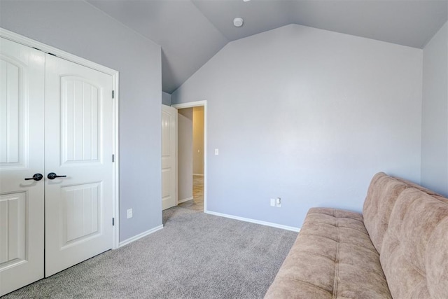 living area featuring light carpet and vaulted ceiling