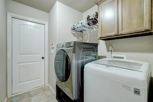 washroom with cabinets and separate washer and dryer