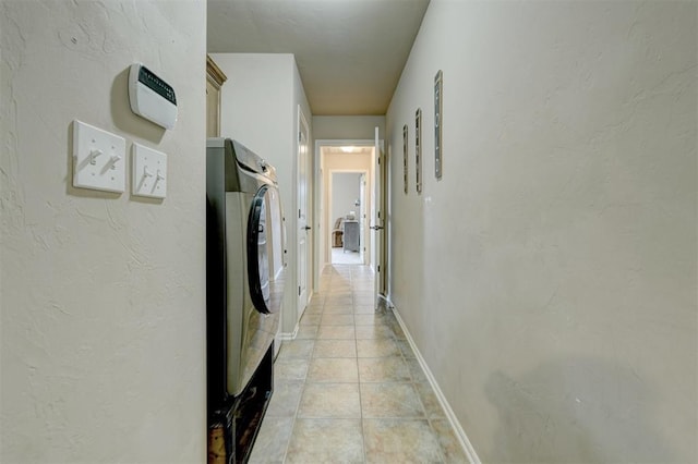 hall with light tile patterned floors and washer / clothes dryer