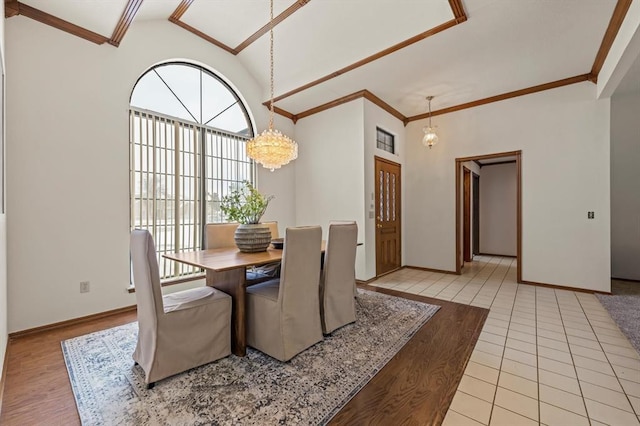 dining space with crown molding, a notable chandelier, light wood-style flooring, and baseboards