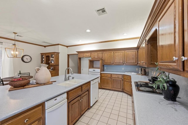 kitchen featuring light countertops, a sink, visible vents, and white dishwasher