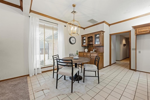 dining space with ornamental molding, light tile patterned flooring, visible vents, and an inviting chandelier