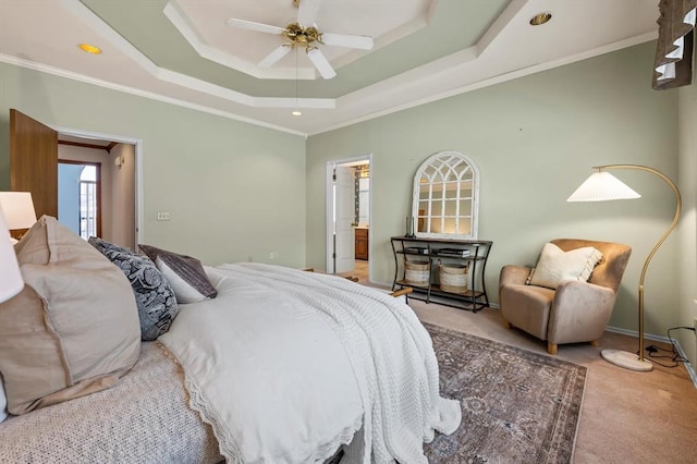 bedroom featuring a tray ceiling, ornamental molding, a ceiling fan, and light colored carpet