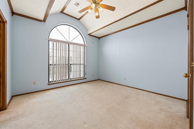 spare room with lofted ceiling, visible vents, light carpet, ceiling fan, and baseboards