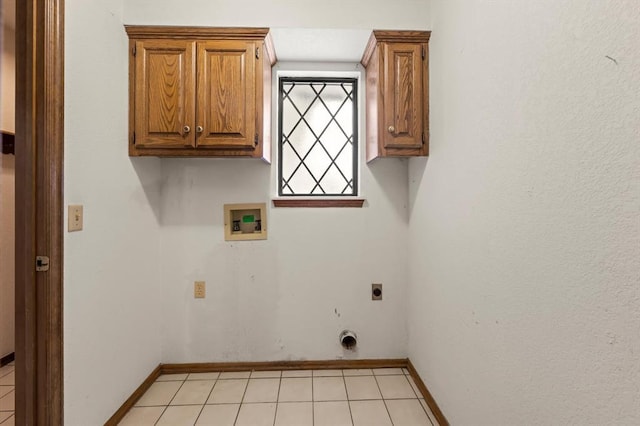 clothes washing area with cabinet space, baseboards, washer hookup, and electric dryer hookup