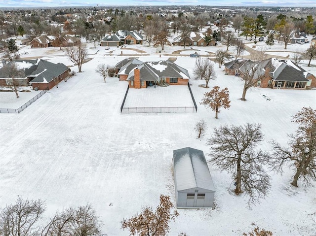 snowy aerial view with a residential view