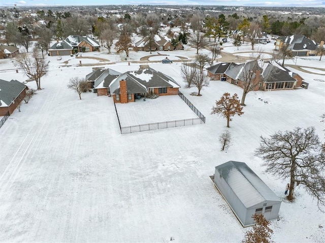 snowy aerial view featuring a residential view