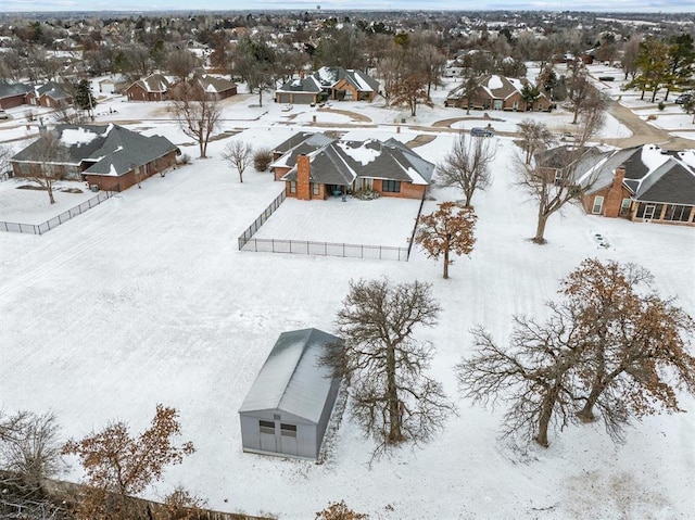 snowy aerial view with a residential view