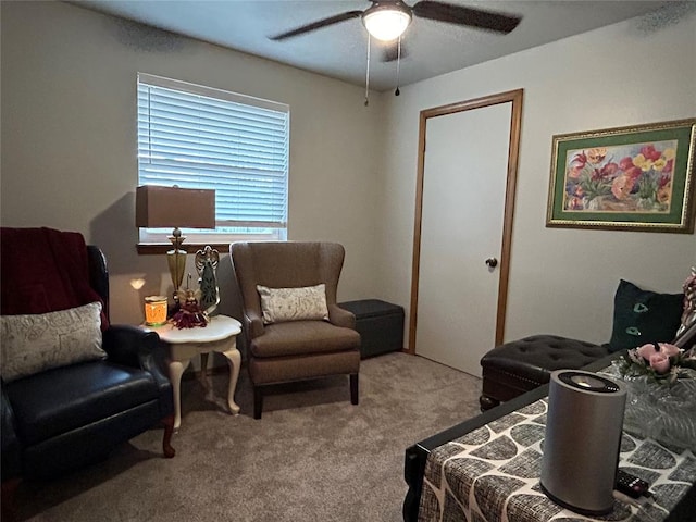 living area featuring light colored carpet and ceiling fan