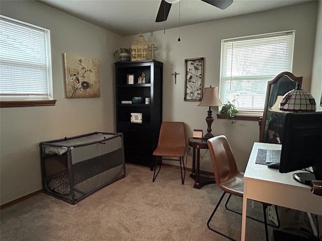 carpeted office space featuring ceiling fan