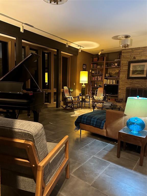 sitting room with dark tile patterned flooring and track lighting