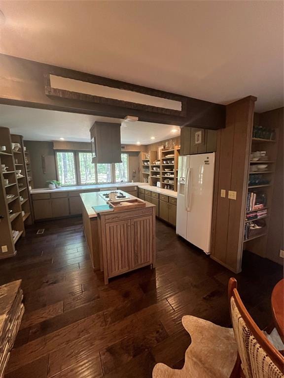 kitchen featuring white appliances, dark wood-type flooring, and kitchen peninsula