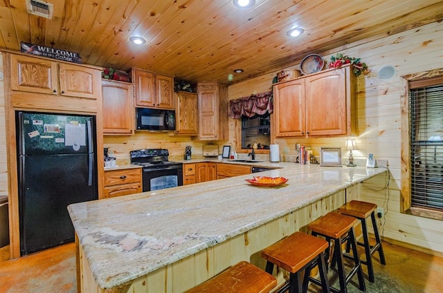 kitchen featuring a peninsula, wood ceiling, visible vents, a kitchen breakfast bar, and black appliances