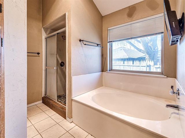 bathroom with plus walk in shower and tile patterned flooring