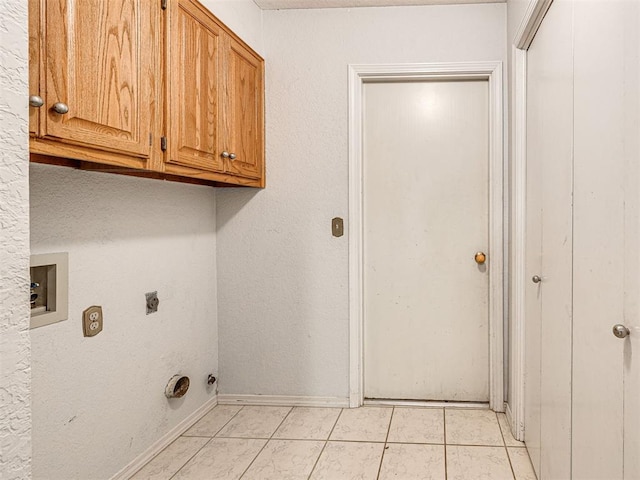 clothes washing area featuring light tile patterned floors, washer hookup, cabinets, and electric dryer hookup