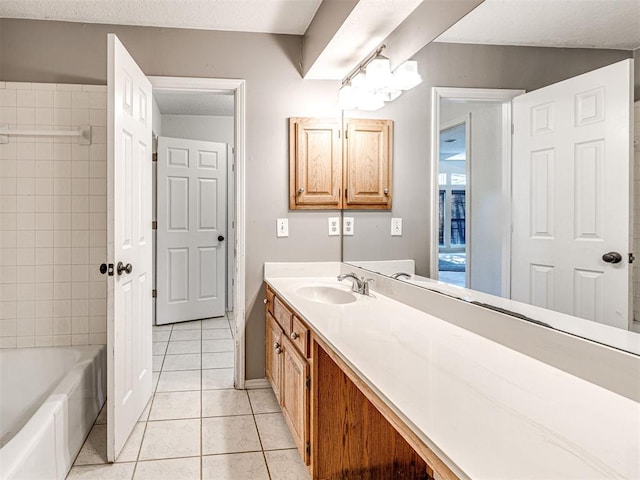 bathroom featuring tile patterned flooring, vanity, and a textured ceiling